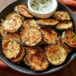 Knusprige Zucchini-Chips serviert mit einem cremigen Kräuterdip